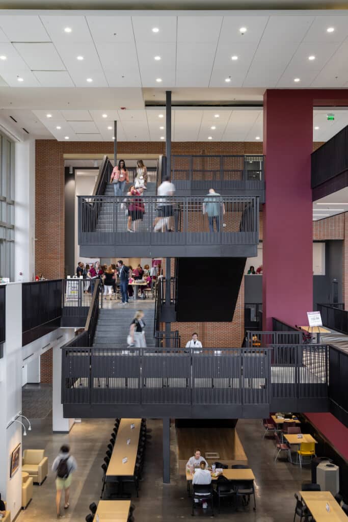 A view of the balconies in the FSU Student Union. They are connected by wide staircases and "float" above the food court area.