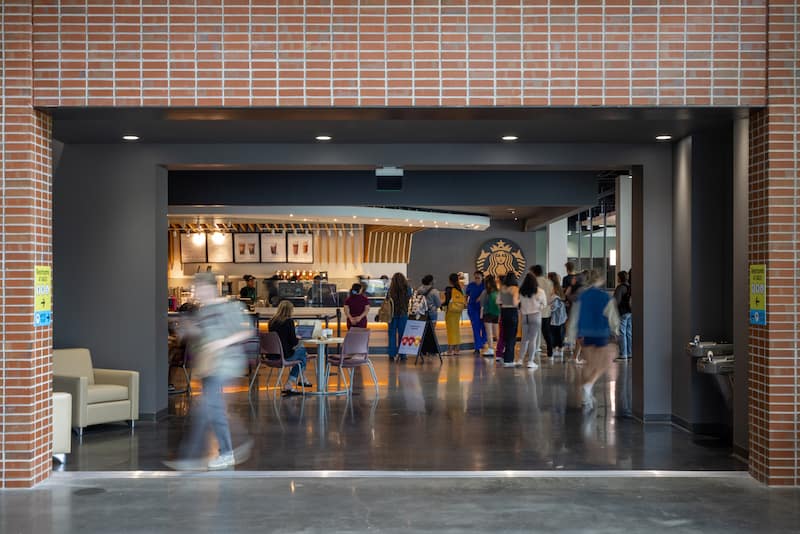 Image of a bustling FSU Student Union building, peeking into the cafeteria with a Starbucks coffee shop.