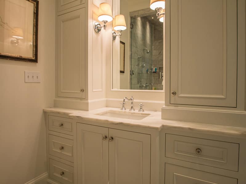 White bathroom vanity marble countertop and custom cabinetry.
